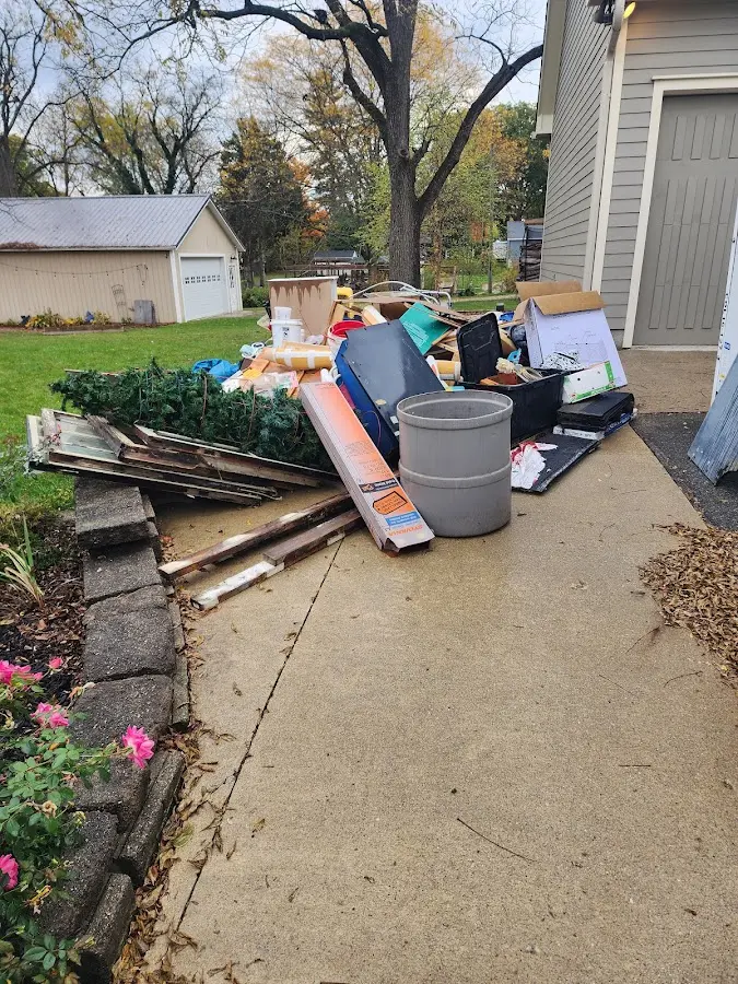 Dumpster being loaded with debris for 12 Yard Dumpster Rental in Chautauqua